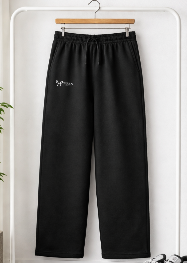 Black pants with a logo on a hanger against a white background