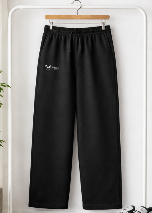 Black pants with a logo on a hanger against a white background