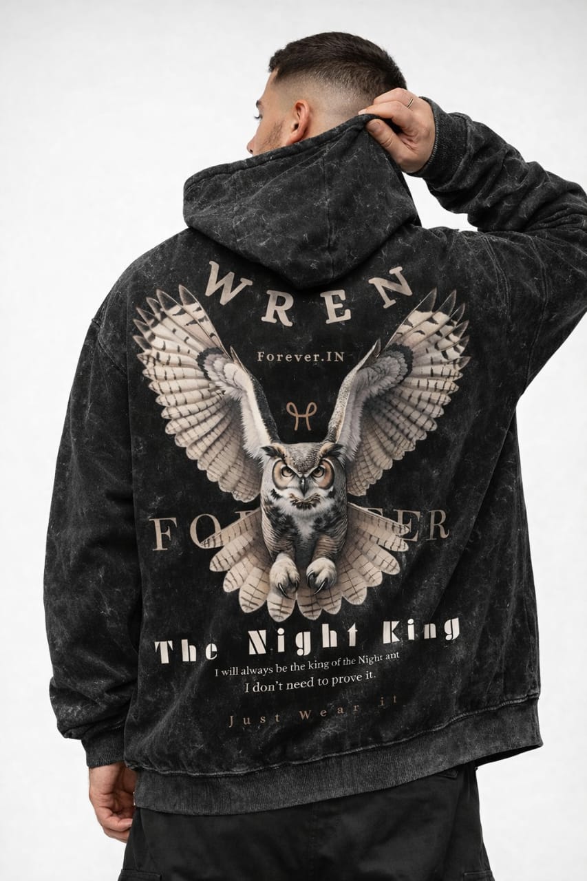 Person wearing a black hoodie with an owl graphic and text on the back, on a white background